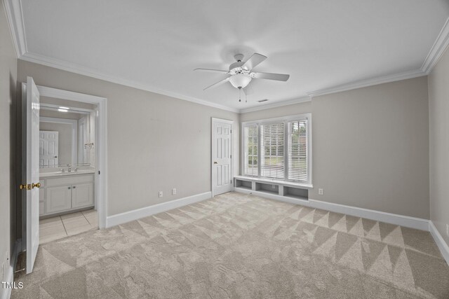2035 Stuart Ct, Burlington, NC 27215 - unfurnished bedroom with light colored carpet, ornamental molding, baseboards, a sink, and ensuite bath