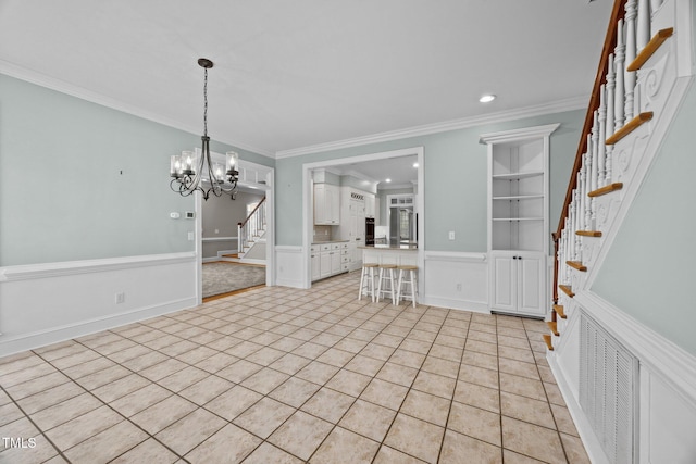 2035 Stuart Ct, Burlington, NC 27215 - entryway featuring stairs, crown molding, wainscoting, light tile patterned flooring, and a decorative wall