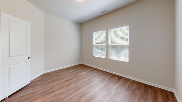 empty room with dark hardwood / wood-style floors