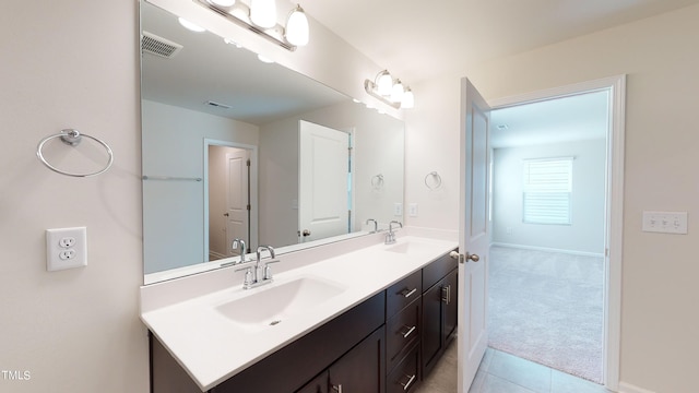 bathroom with tile patterned flooring and vanity