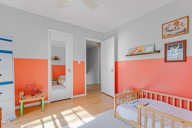 bedroom featuring light hardwood / wood-style flooring and ceiling fan