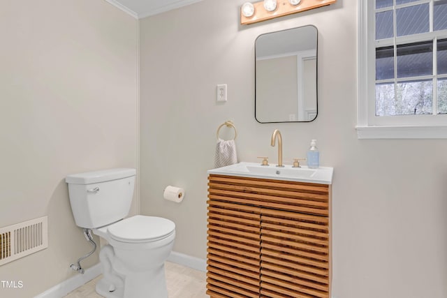 bathroom featuring vanity, crown molding, and toilet