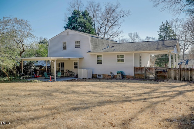 rear view of property featuring a patio and a lawn