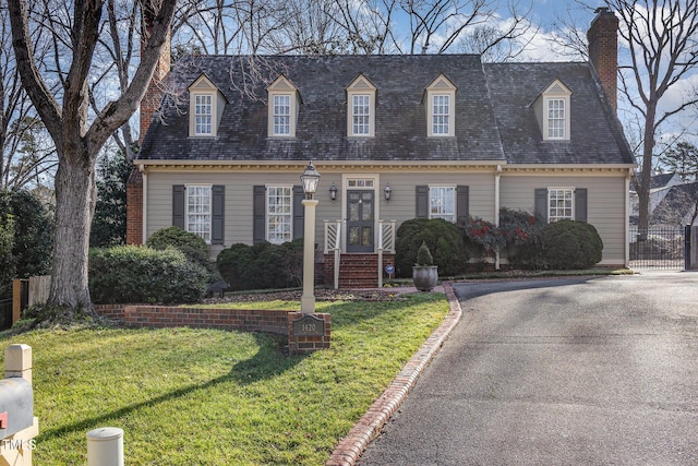 new england style home with a front lawn