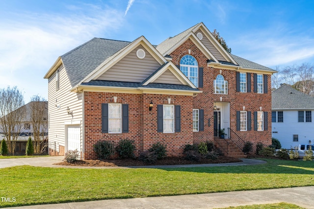 view of front of home with a garage and a front yard