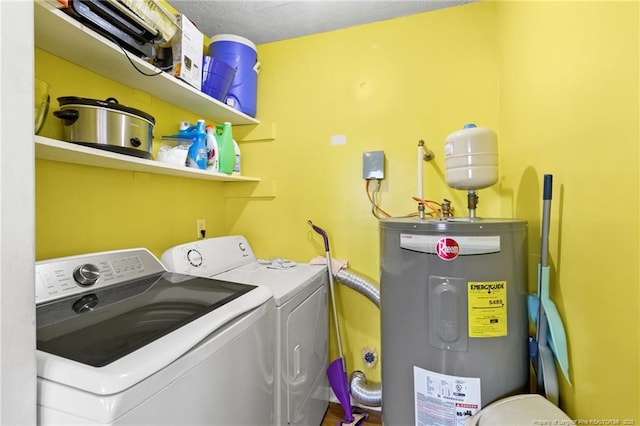 washroom featuring water heater and washing machine and clothes dryer