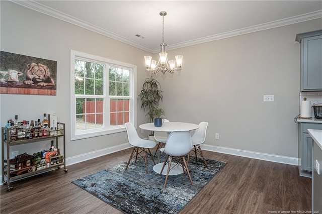 dining room featuring crown molding, an inviting chandelier, and dark wood-type flooring