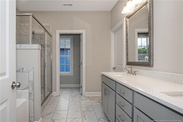 bathroom with vanity and a shower with shower door