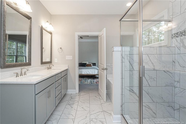 bathroom featuring an enclosed shower, vanity, and a wealth of natural light