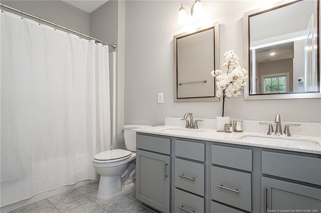 full bathroom with vanity, shower / bath combination with curtain, and toilet