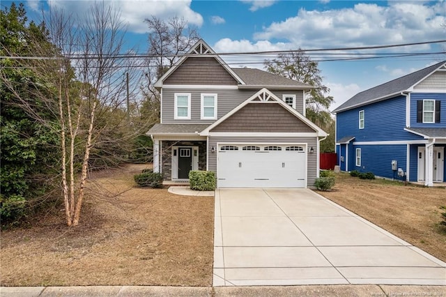 view of front of home featuring a garage and a front yard