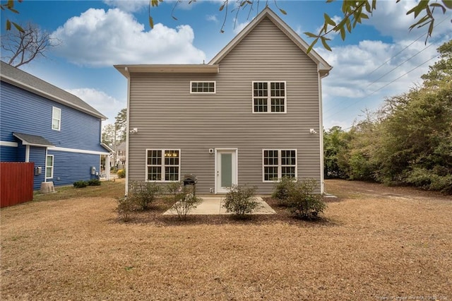 rear view of house with a patio and a lawn