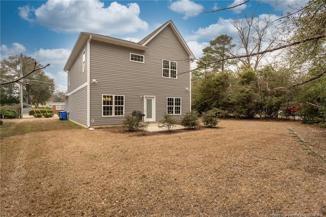 rear view of house with a yard