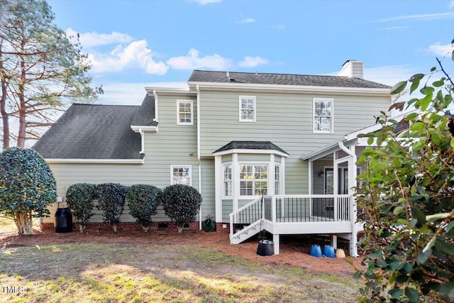 rear view of property featuring a sunroom