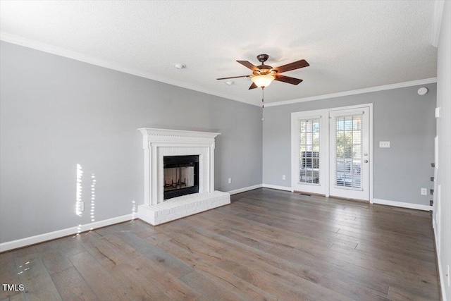 unfurnished living room with ornamental molding, hardwood / wood-style floors, a textured ceiling, and a fireplace