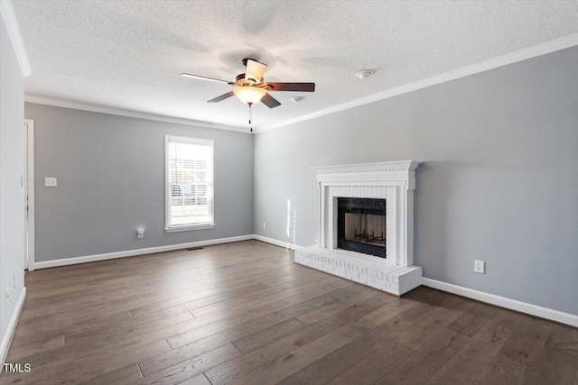 unfurnished living room featuring crown molding, dark hardwood / wood-style floors, ceiling fan, and a fireplace