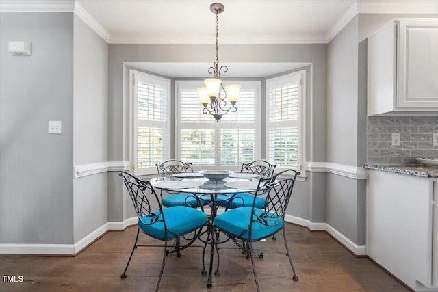 dining area featuring crown molding, an inviting chandelier, and dark hardwood / wood-style flooring