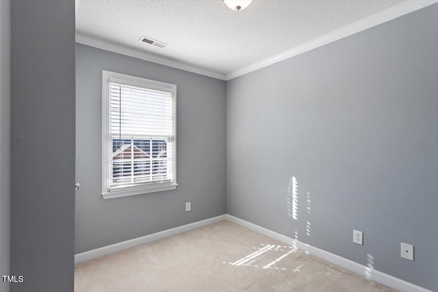 empty room with crown molding, light colored carpet, and a textured ceiling