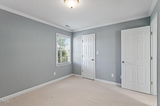 unfurnished bedroom featuring crown molding, light carpet, and a textured ceiling