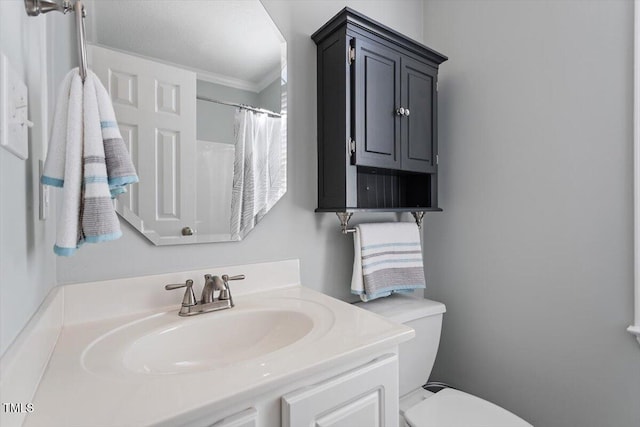 bathroom with vanity, toilet, and curtained shower