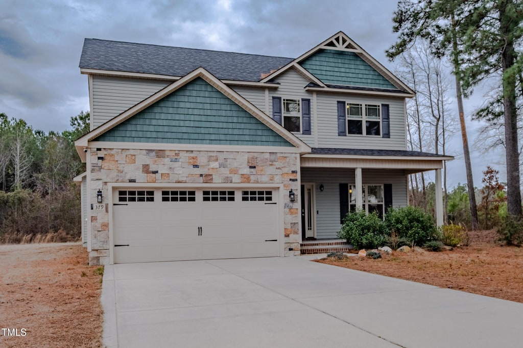 craftsman house featuring a garage and covered porch