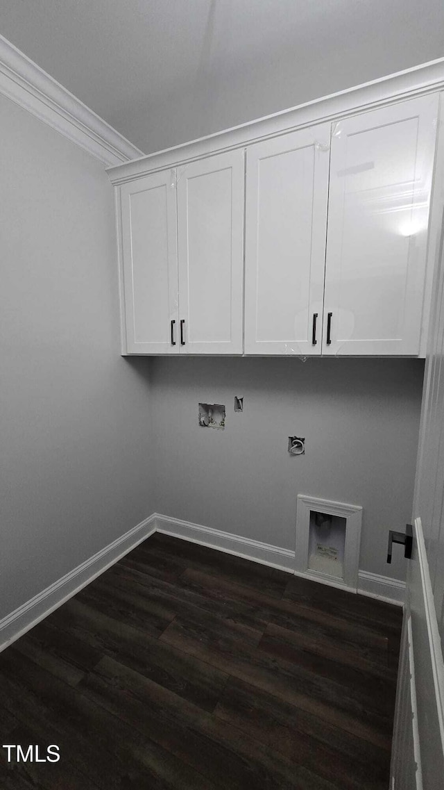 1203 Elizabeth Rd W, Wilson, NC 27896 - laundry room featuring cabinet space, hookup for a washing machine, dark wood-style floors, crown molding, and hookup for an electric dryer