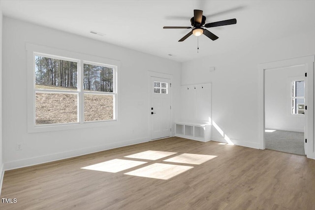 unfurnished living room featuring ceiling fan and light wood-type flooring