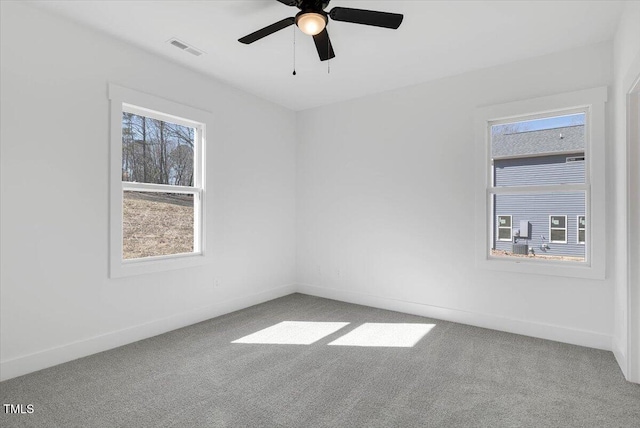 unfurnished room featuring ceiling fan and carpet