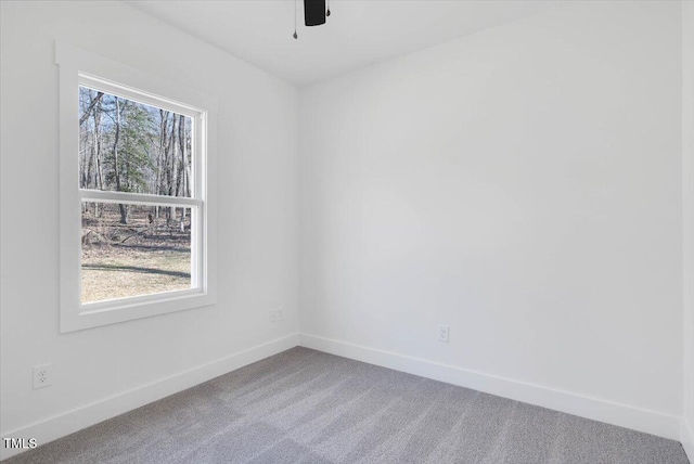 carpeted empty room featuring ceiling fan and a healthy amount of sunlight