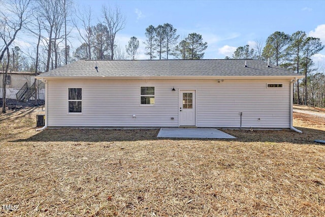 back of house with a patio and a lawn