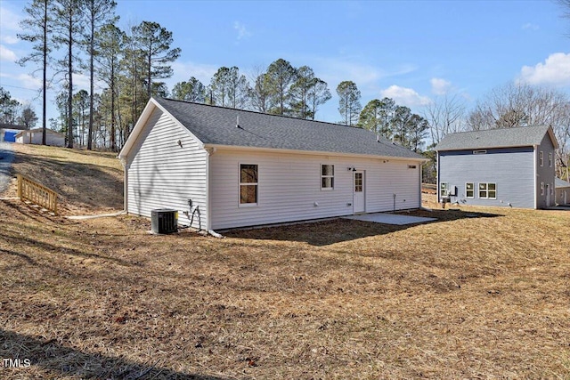 back of house with cooling unit, a patio area, and a lawn