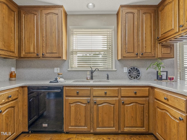 kitchen with a wealth of natural light, black dishwasher, sink, and backsplash