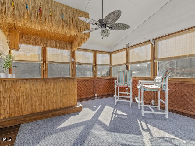 unfurnished sunroom with a wealth of natural light, vaulted ceiling, and ceiling fan