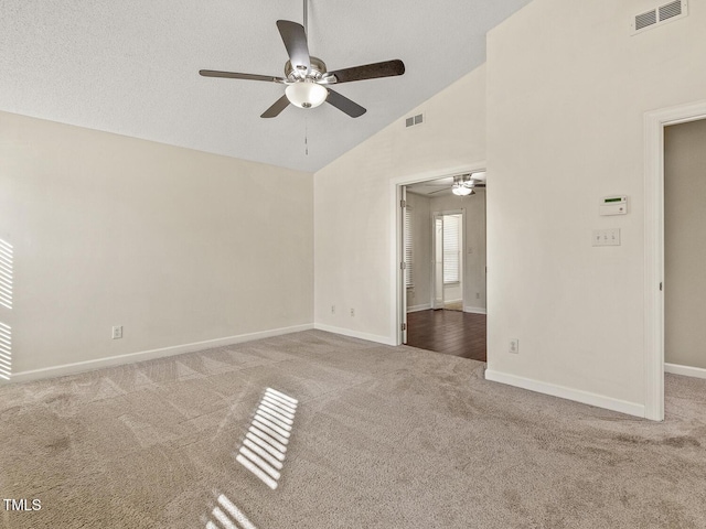 carpeted spare room with ceiling fan, high vaulted ceiling, and a textured ceiling