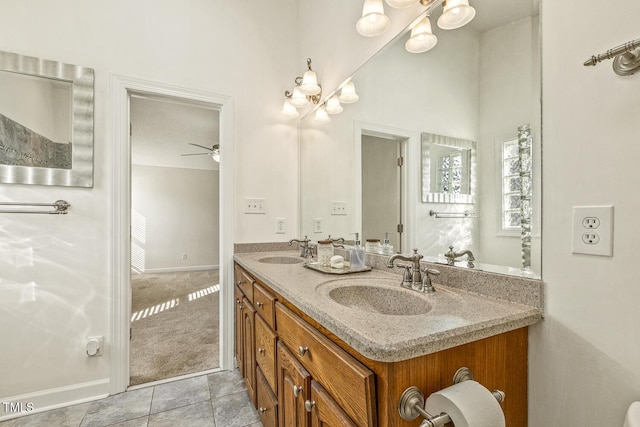 bathroom with vanity, ceiling fan with notable chandelier, and tile patterned floors