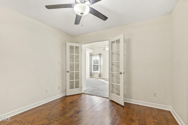 unfurnished room with ceiling fan, dark wood-type flooring, french doors, and a textured ceiling