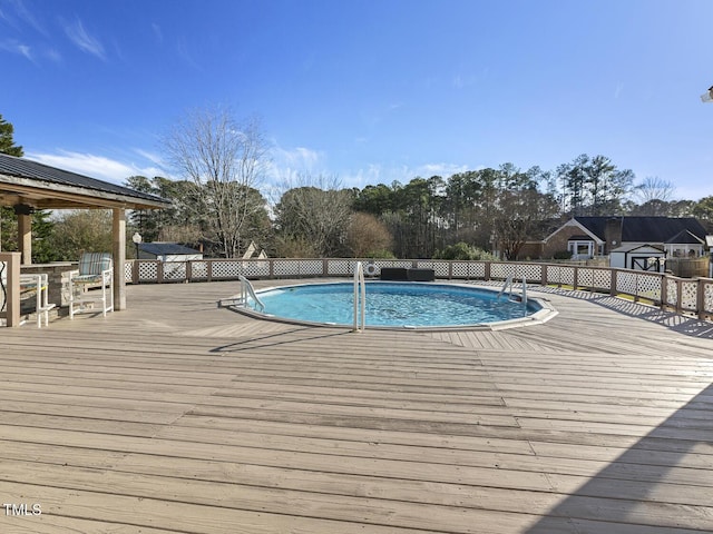 view of swimming pool featuring a gazebo and a deck