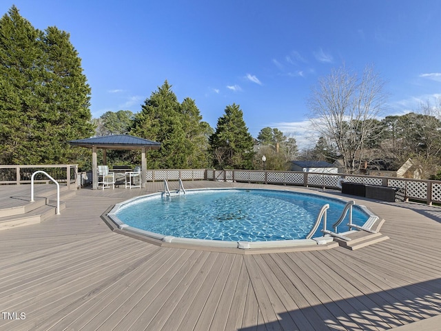 view of pool featuring a gazebo and a deck