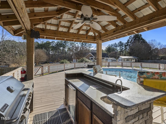 view of patio / terrace with a bar, grilling area, and a pool side deck