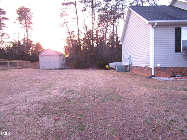 yard at dusk with a shed