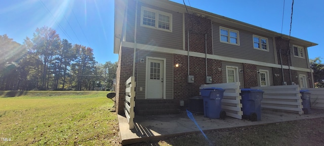 back of house with a lawn