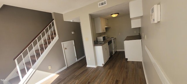 kitchen featuring white cabinetry, dishwashing machine, and dark hardwood / wood-style floors