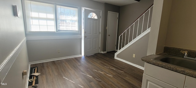 entryway with sink and dark hardwood / wood-style flooring