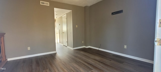 unfurnished room with dark hardwood / wood-style floors and a textured ceiling