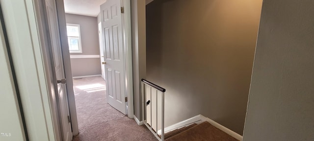 corridor featuring light colored carpet