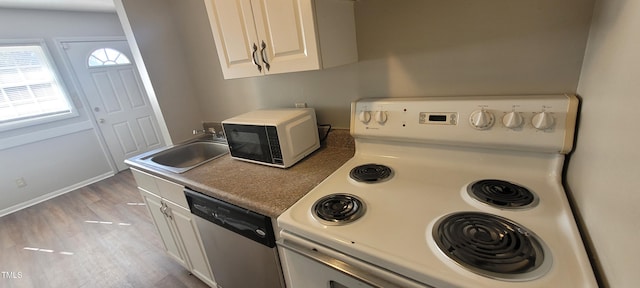 kitchen featuring sink, white electric range, dishwasher, white cabinets, and light wood-type flooring