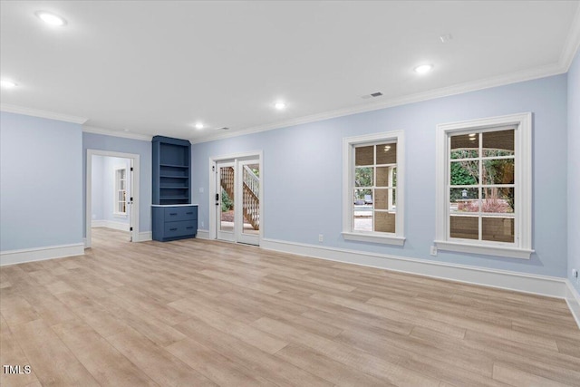 interior space with ornamental molding, visible vents, light wood-style flooring, and baseboards