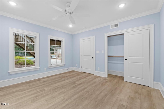 unfurnished bedroom with ornamental molding, light wood finished floors, and visible vents