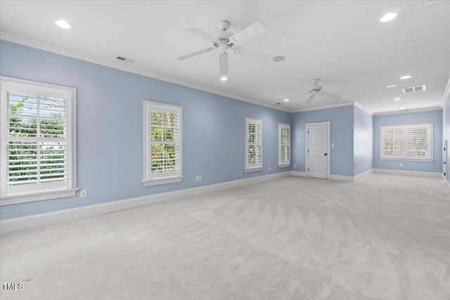 unfurnished room featuring baseboards, a wealth of natural light, visible vents, and light colored carpet