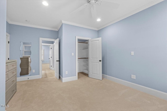 unfurnished bedroom with a walk in closet, crown molding, recessed lighting, light carpet, and baseboards